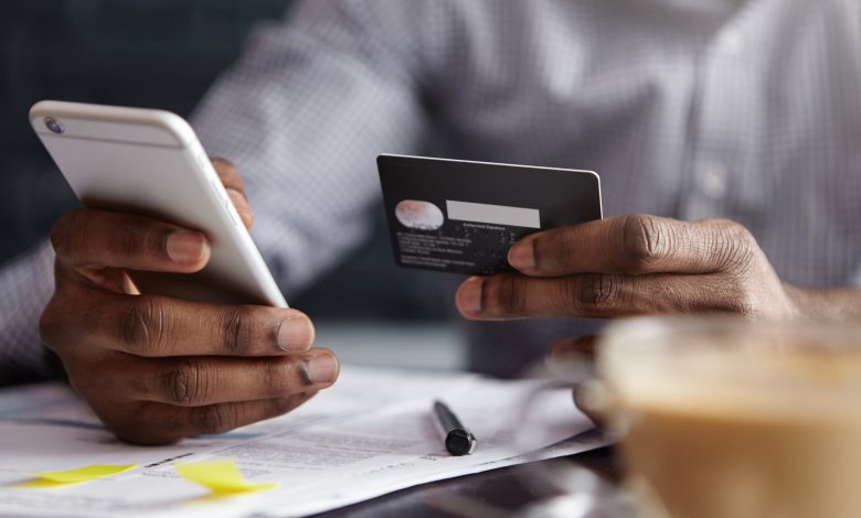 cropped shot of african american businessman paying with credit card online