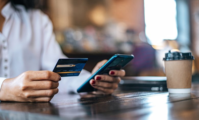 pay for goods by credit card through a smartphone in a coffee shop